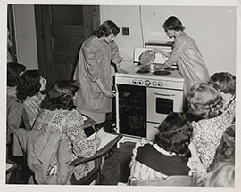 Photograph of students looking at a stove
