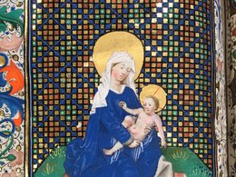 Medieval illustration featuring Virgin Mary holding baby Jesus and colorful, ornate shapes