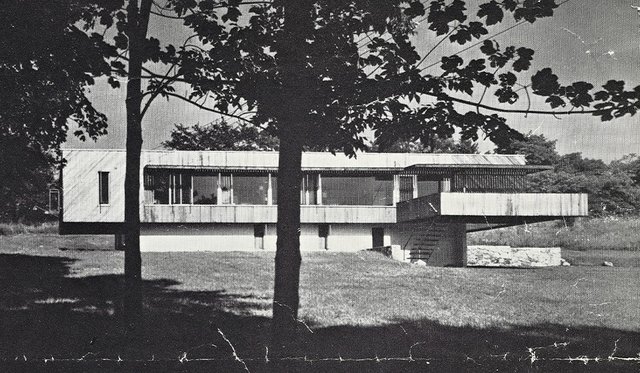 Black and white scanned image of a Marcel Breuer house flanked by trees